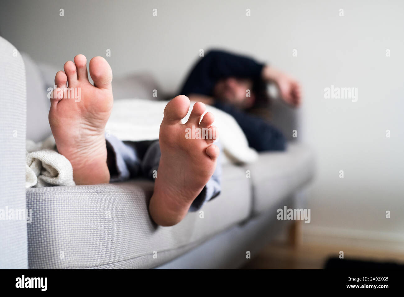 Man sleeping on sofa Stock Photo
