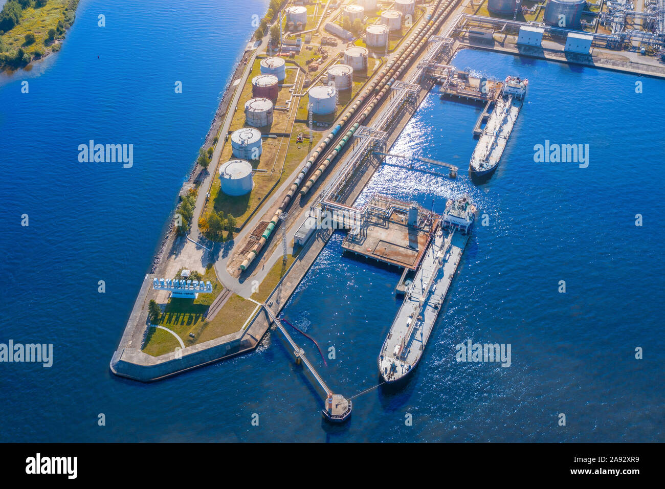 Aerial view large port oil loading terminal with large storage tanks. Railway infrastructure for the delivery of bulk cargo by sea, using pump station Stock Photo