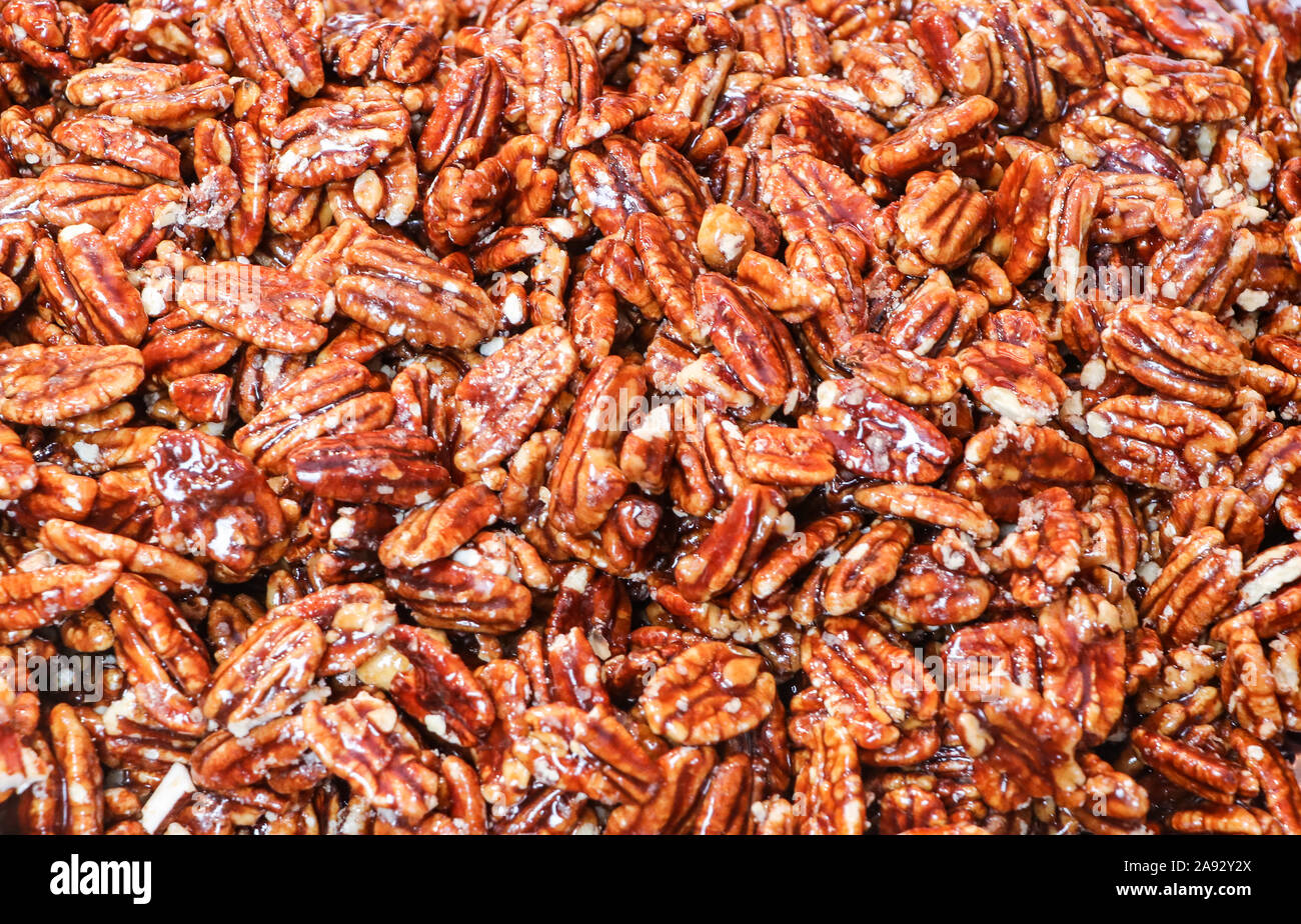 Sweet glazed covered pecans shelled and ready to enjoy from the food market Stock Photo