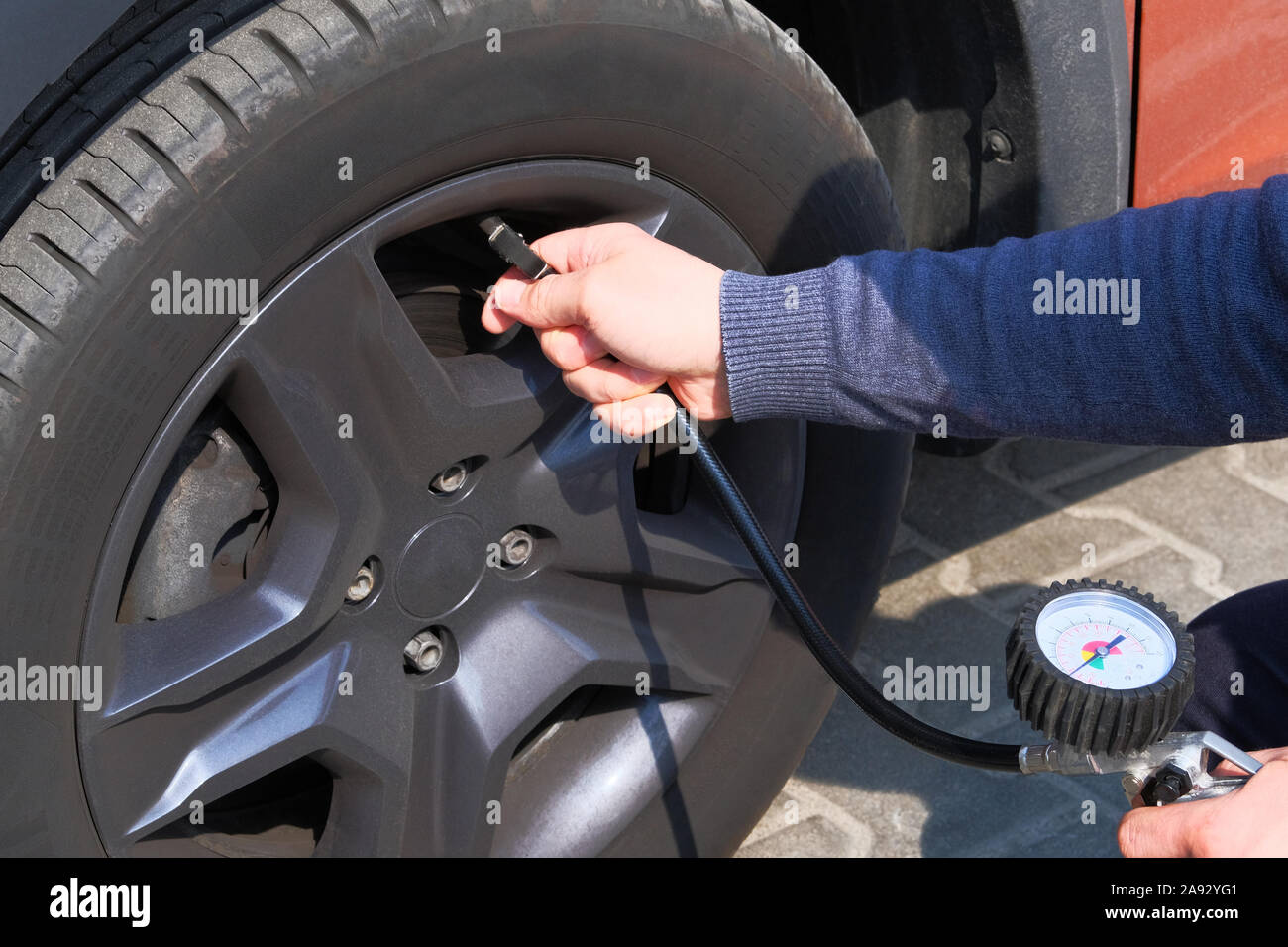 Automobile maintenance concept. Car service. Male hand checks pressure