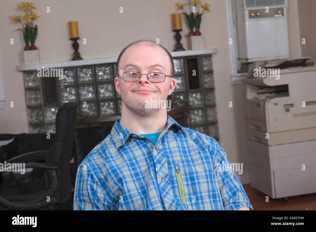 Man with Down Syndrome working in an office Stock Photo