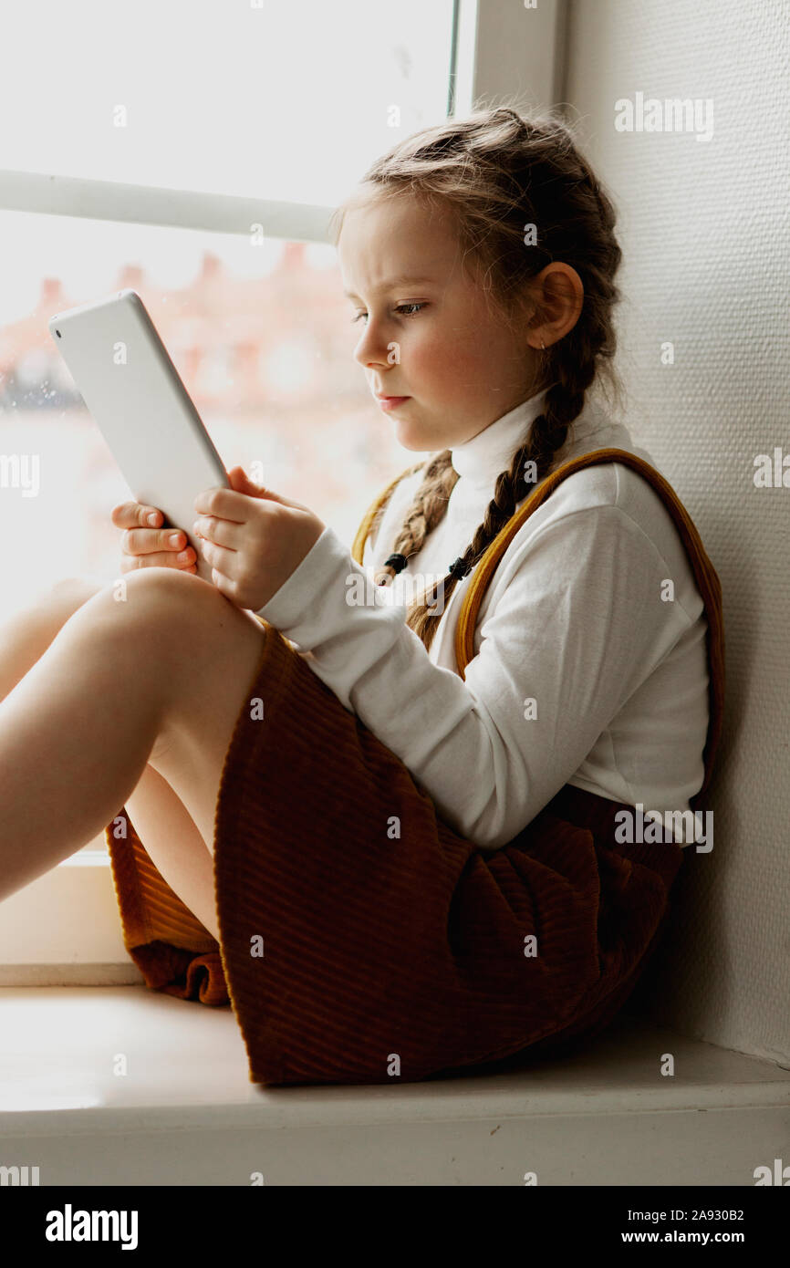 Girl using digital tablet Stock Photo