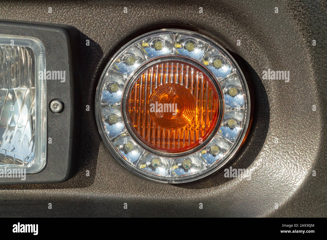 LED headlight with integrated turn signal lamp. Fragment of the front of the vehicle. Stock Photo