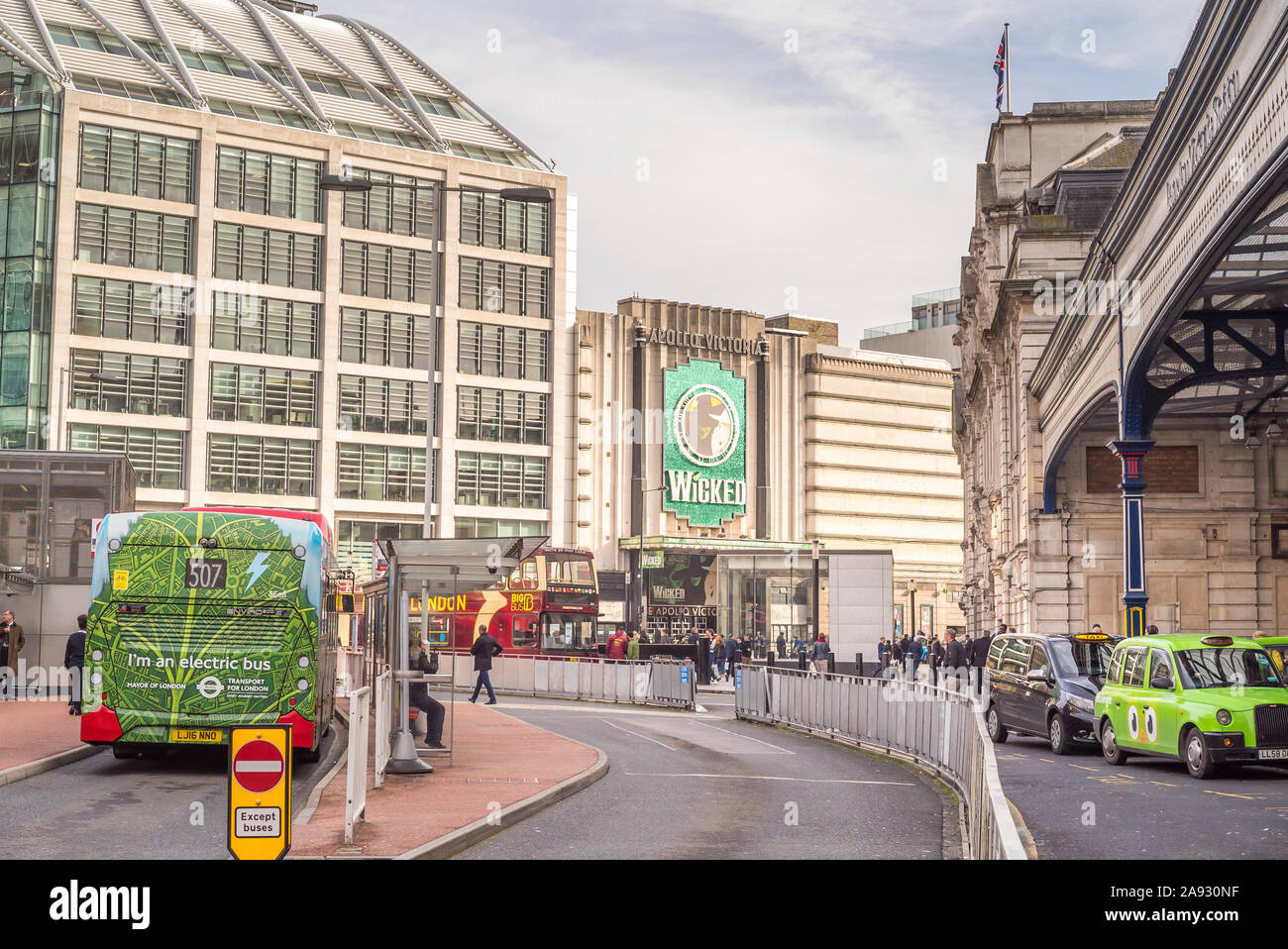 Exterior view of the Apollo Victoria Theatre advertising the musical production Wicked outside busy London Victoria train station. Stock Photo