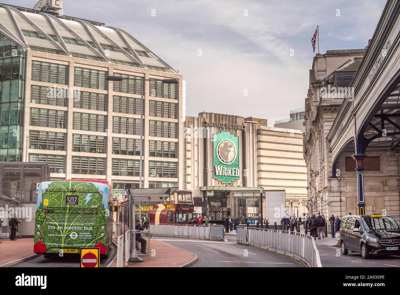 View of the West End's Apollo Victoria Theatre advertising the long-running, hit musical production Wicked outside busy London Victoria train station. Stock Photo