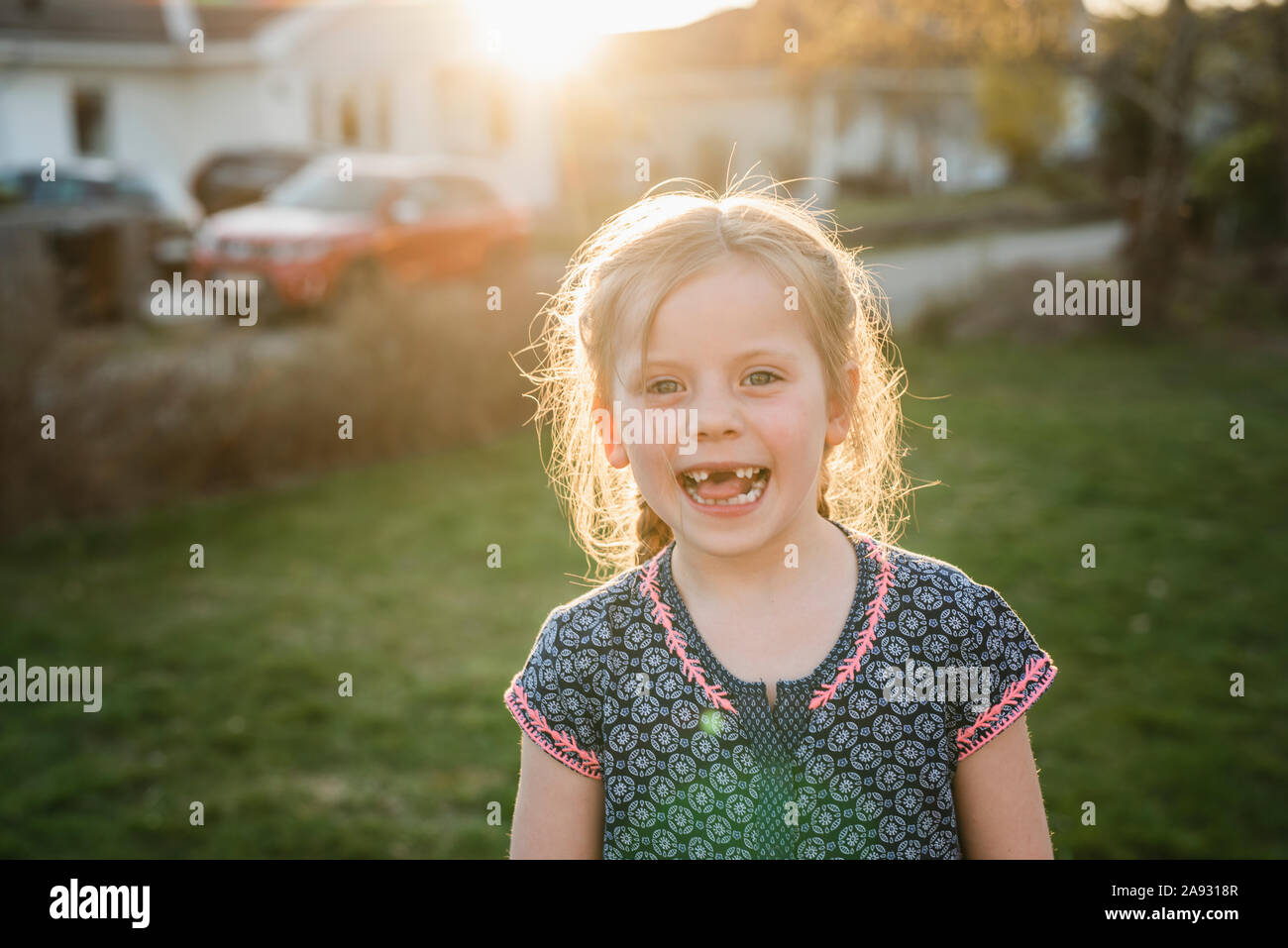 Happy girl looking at camera Stock Photo - Alamy