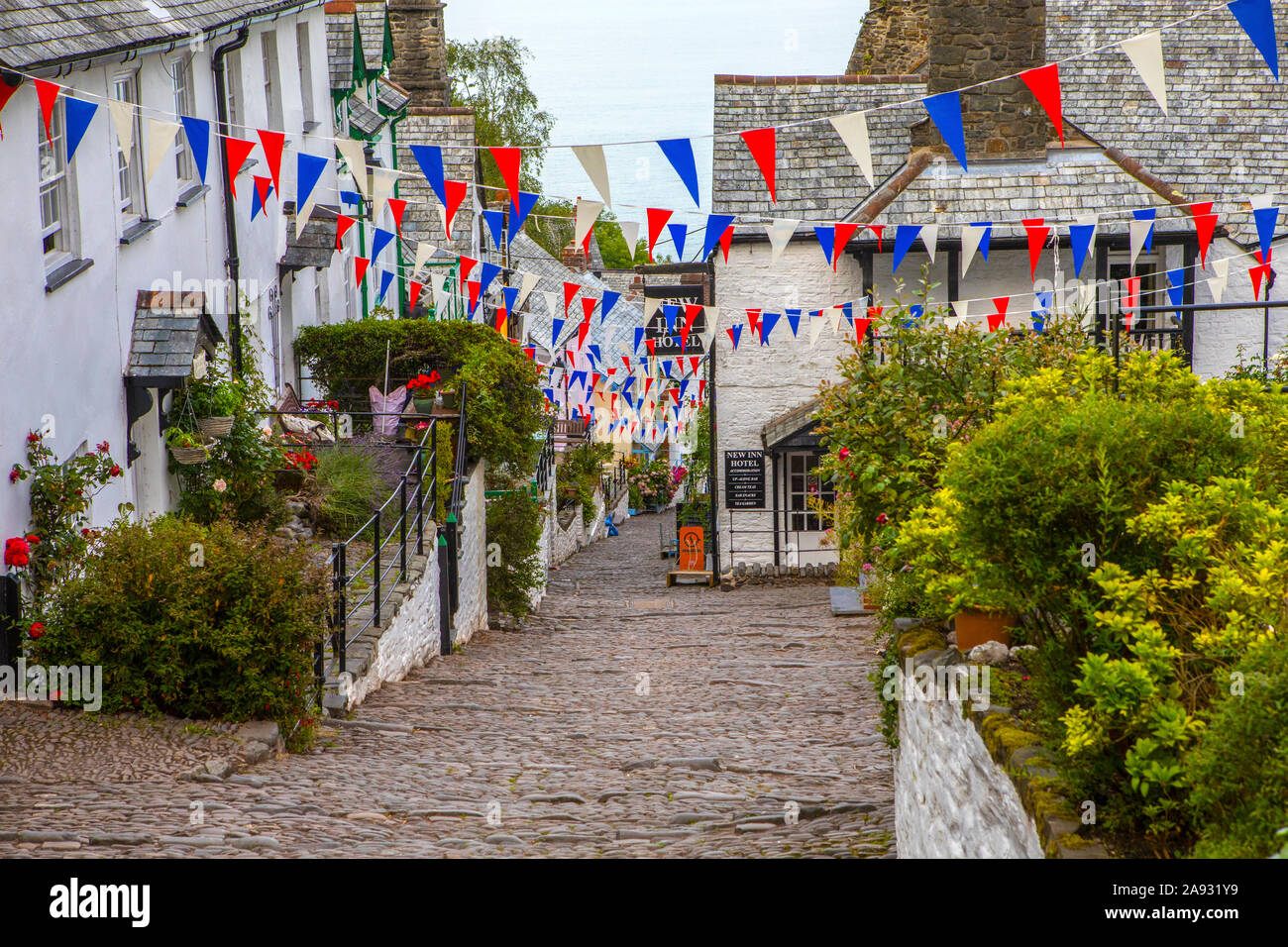 Devon, UK - August 2nd 2019: A view down the picturesque cobbled main street of the fishing village of Clovelly in North Devon, UK. Stock Photo