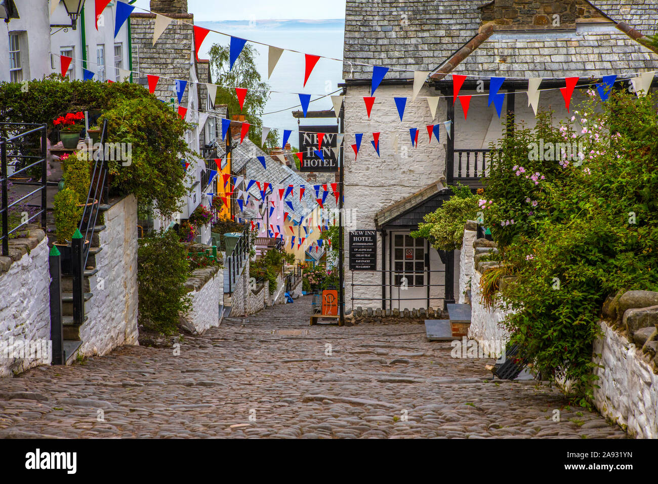 Devon, UK - August 2nd 2019: A view down the picturesque cobbled main street of the fishing village of Clovelly in North Devon, UK. Stock Photo