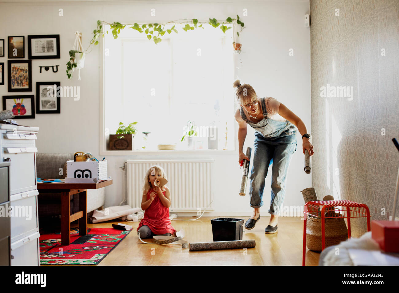 Woman checking wallpaper Stock Photo - Alamy