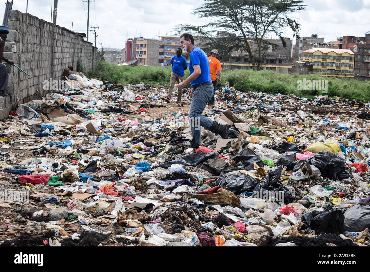 A participant walking in garbage during a clean up exercise in Kasarani.Global plastic ingredients producer, Dow Chemical Company ran an awareness and cleanup project dubbed #projectbutterfly which aims at reducing plastic waste in the environment and fostering circular economy through partnerships with recycling companies. Stock Photo