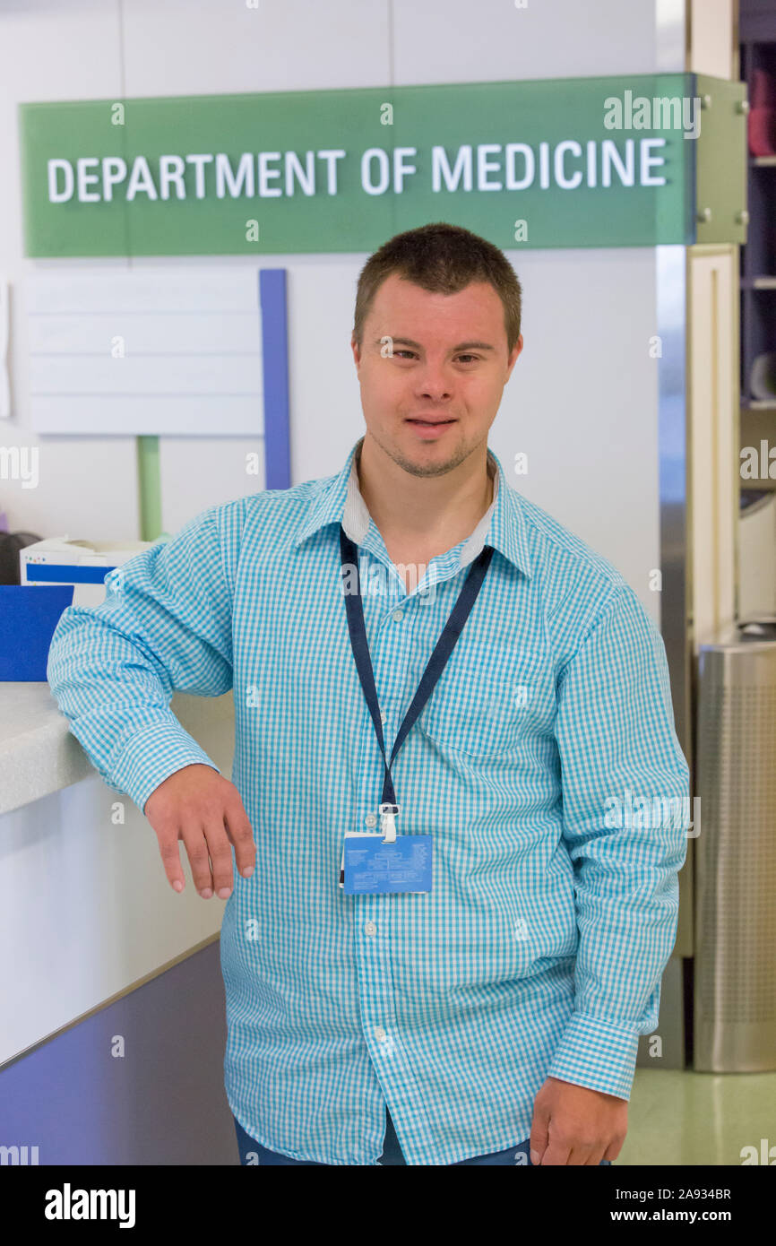Man with Down Syndrome working in a hospital Stock Photo