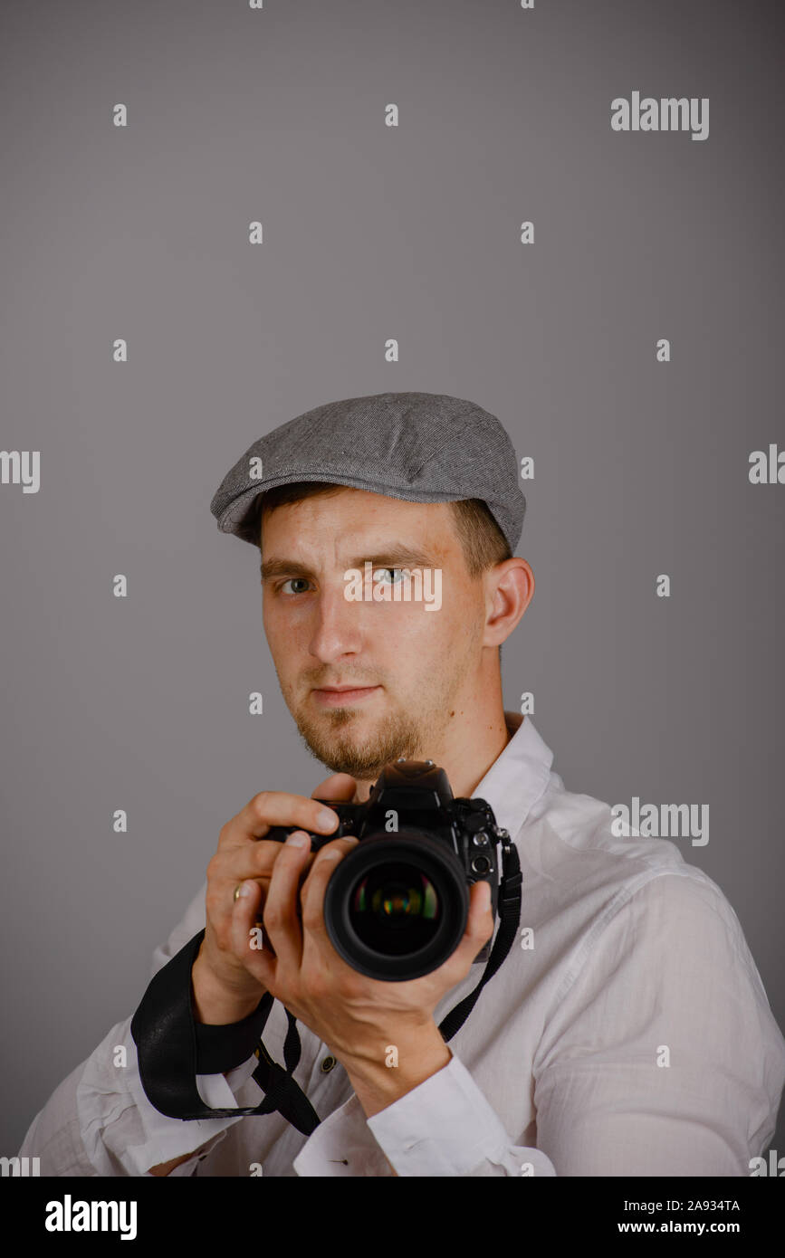 Young man using a professional camera in studio Stock Photo