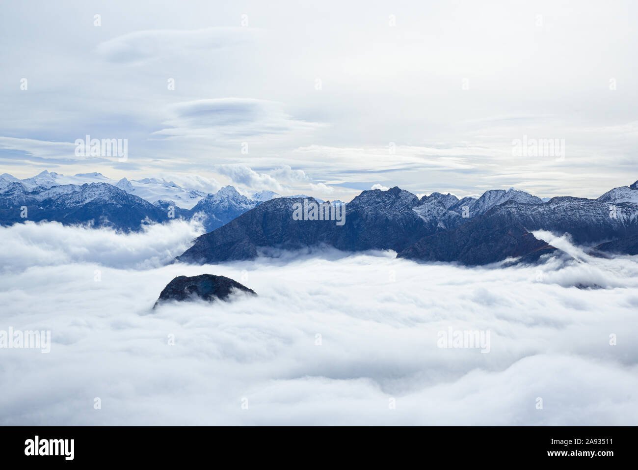 Monte Bianco, Italy. Aerial view of the Alps surrounded by clouds. Stock Photo