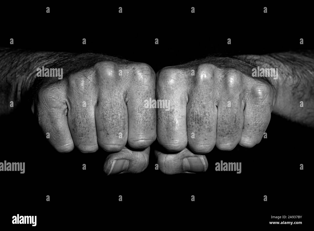 Man's clenched fists side by side, close up. black and white Stock