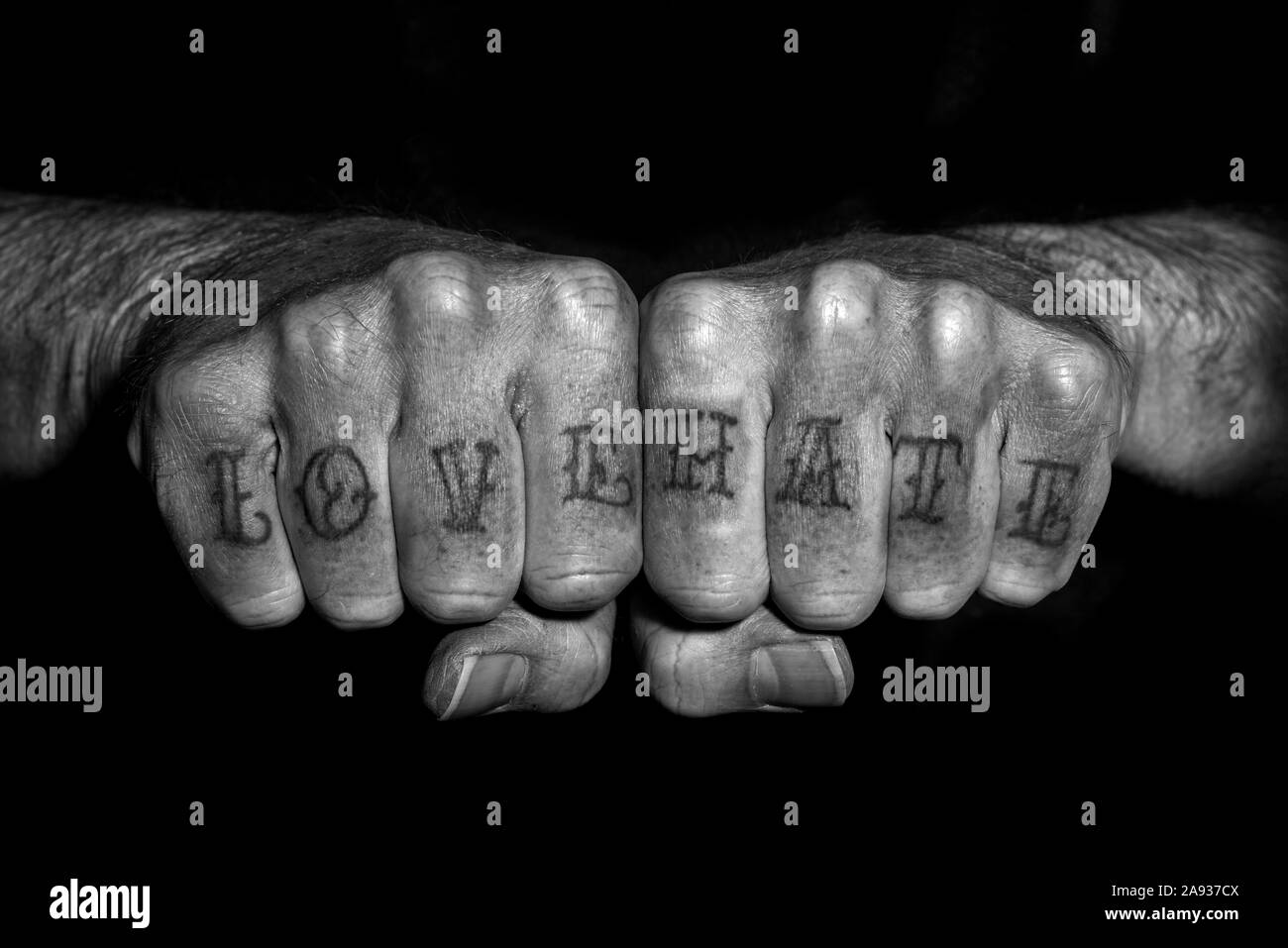 love and hate tattooed oto a mans fists, close up. Stock Photo
