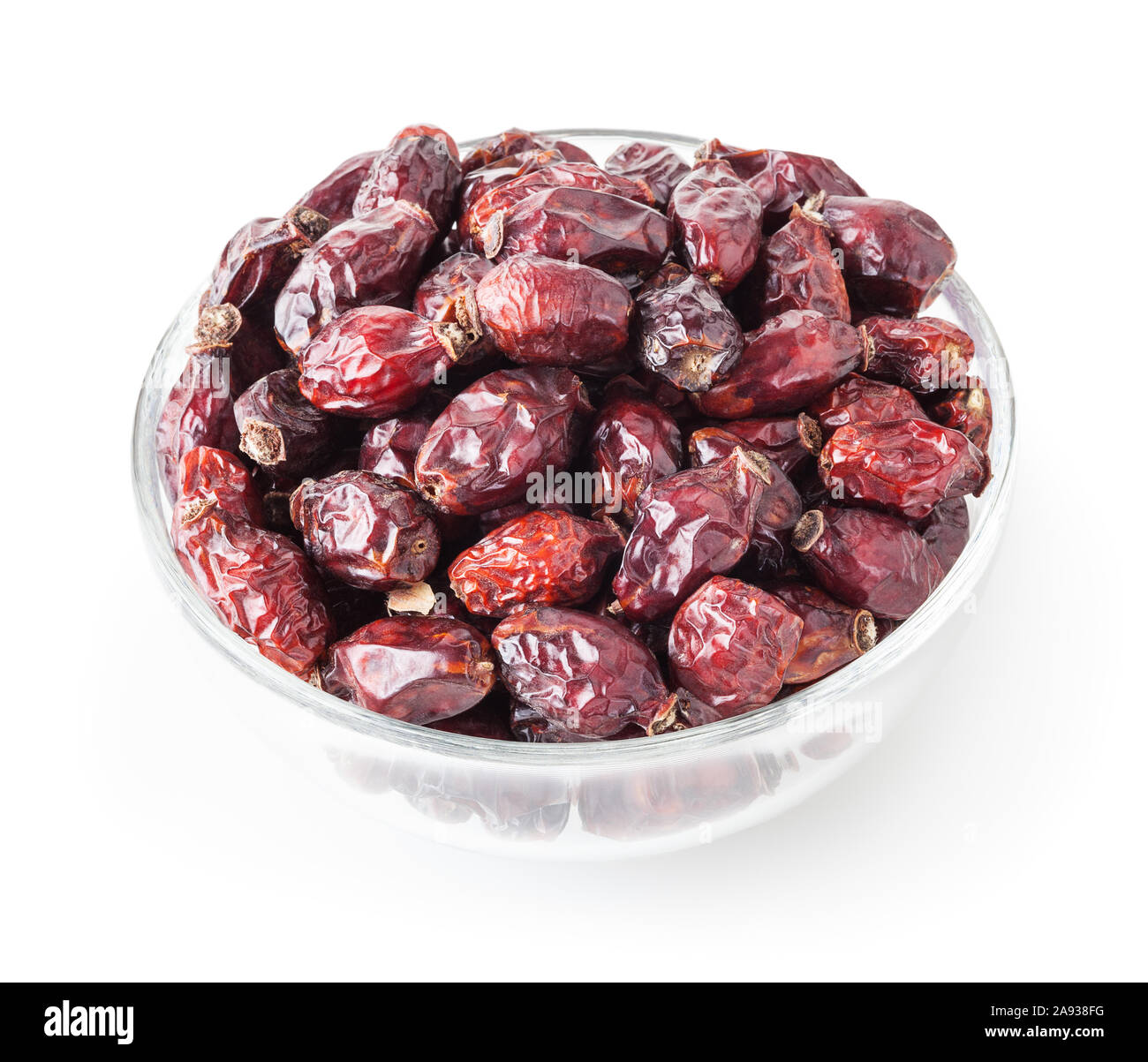 Dried wild rose berries in glass bowl isolated on white background with clipping path Stock Photo