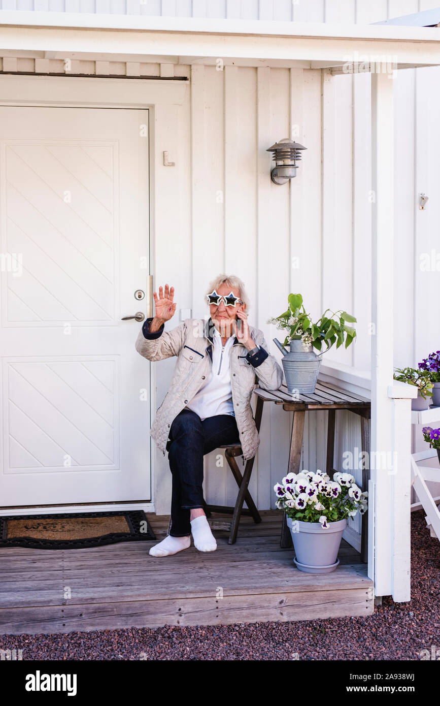Woman sitting on porch Stock Photo - Alamy