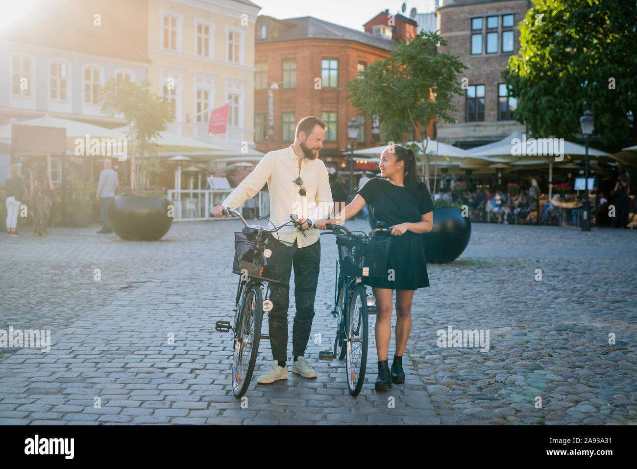 Couple walking with bicycles Stock Photo