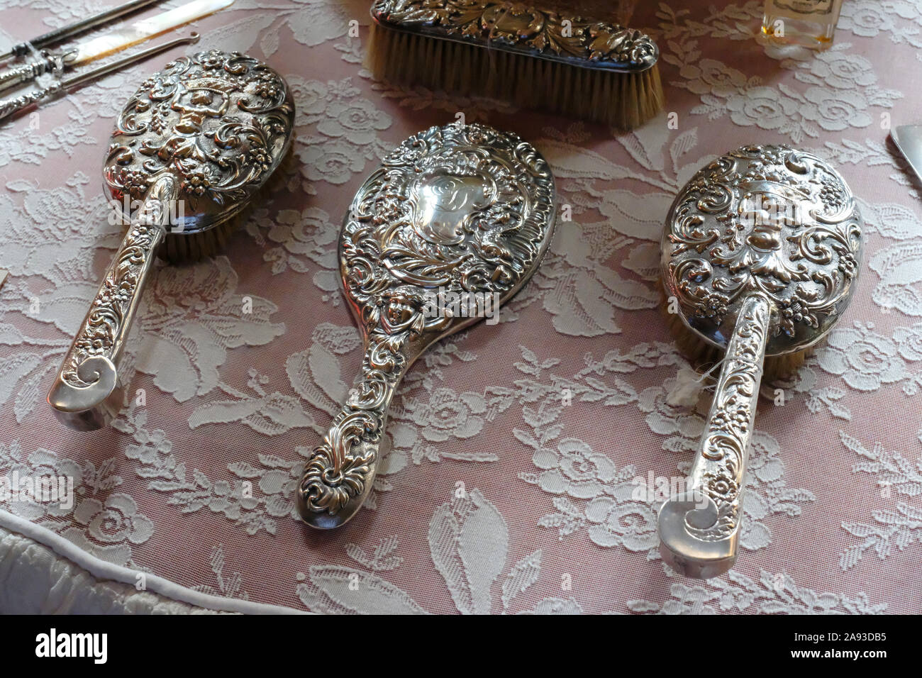 Close-up on a Victorian dressing table with silver hair, clothes brushes and mirror - John Gollop Stock Photo