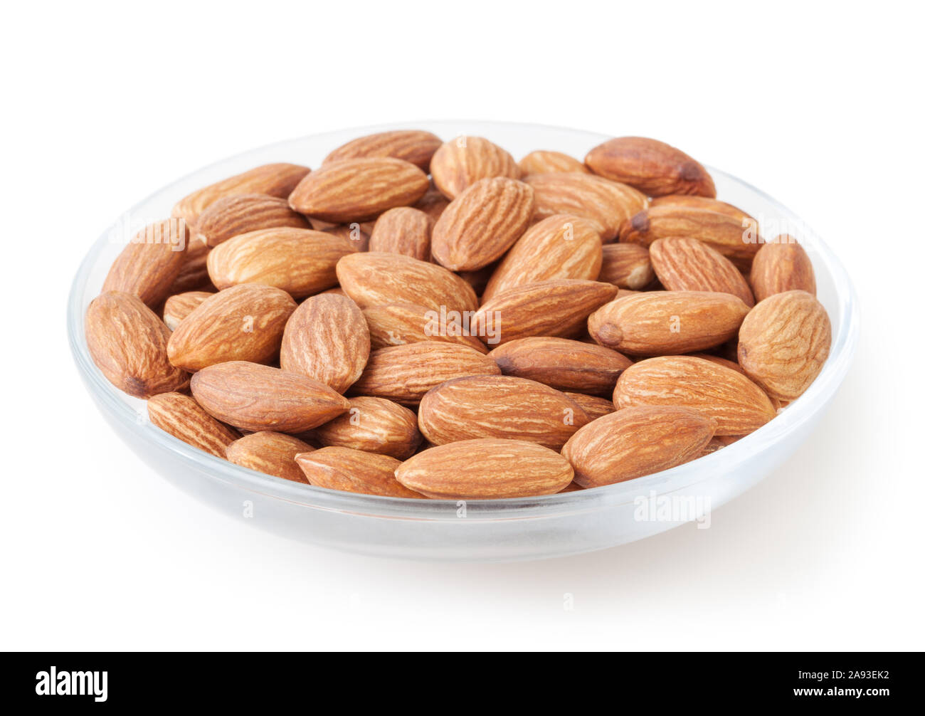 Almonds in glass bowl isolated on white background Stock Photo