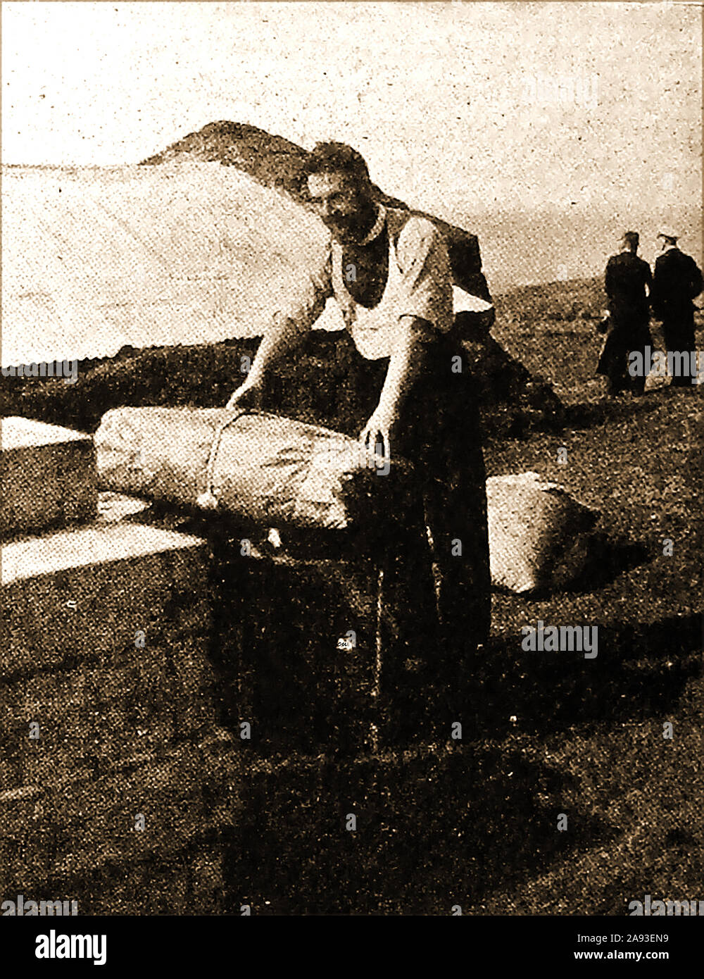 1946 Tristan de Cunha - The Reverend Harold Wilde helps to  sort out recently landed supplies . Stock Photo