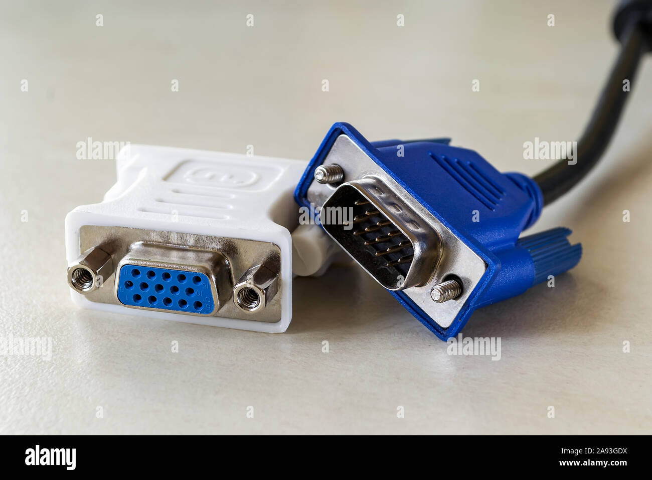 Vga plug of white dvi-d adapter and blue vga socket monitor cord near it.  Connection of computer devices with plugs of different types. Close-up  Stock Photo - Alamy