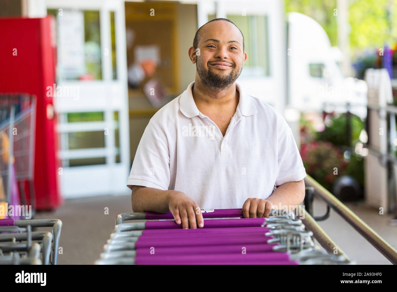 Man with Down Syndrome picking a grocery cart Stock Photo Alamy