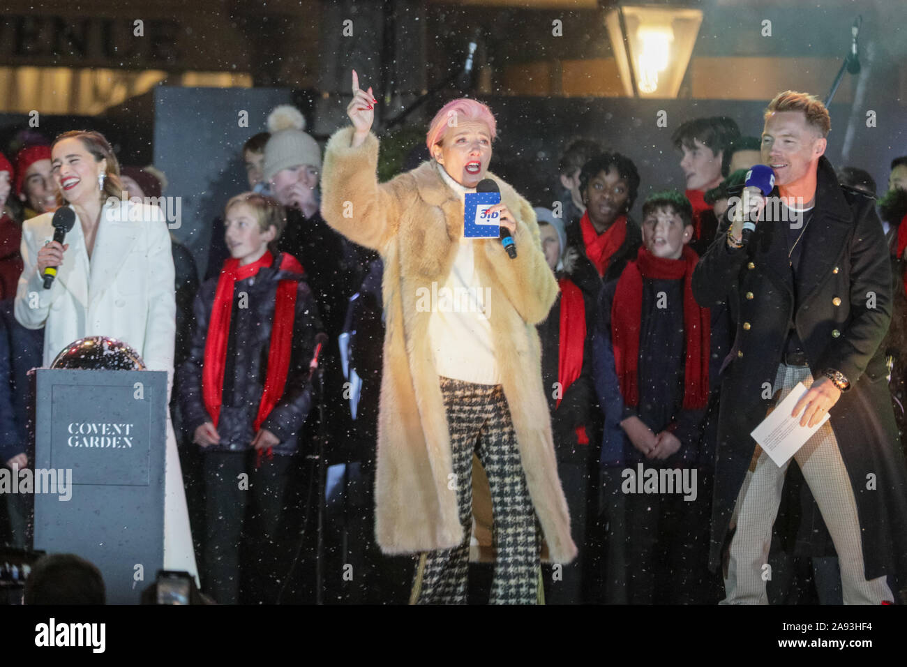 West End, London, UK, 12th November 2019. The stars of the new film 'Last Christmas', actresses Emilia Clarke, (who also starred in Game of Thrones), and British Oscar winning actress Emma Thompson, with director Paul Feig, and presenters of the show, Magic FM's Ronan Keating and Harriet Scott. Spectators watch the annual stage performance and switch on of the beautiful Covent Garden Christmas tree and lights in London's West End. Credit: Imageplotter/Alamy Live News Stock Photo