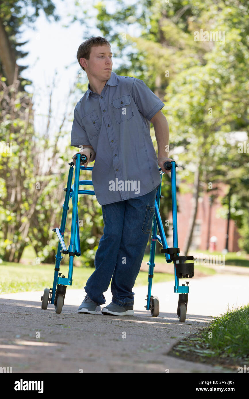 Young man with Cerebral Palsy using his walker to walk to work Stock Photo  - Alamy
