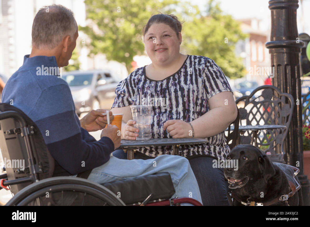 Woman with Visual Impairment sitting at a cafe with her father and