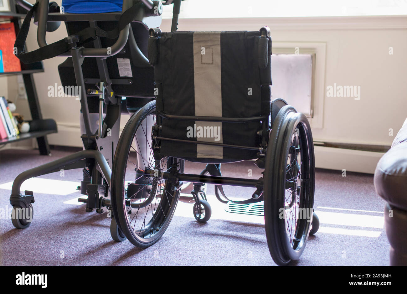 Woman with spinal cord injury getting into her desk so she can stand up