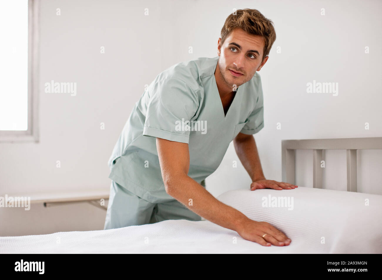Male nurse making hospital bed Stock Photo Alamy
