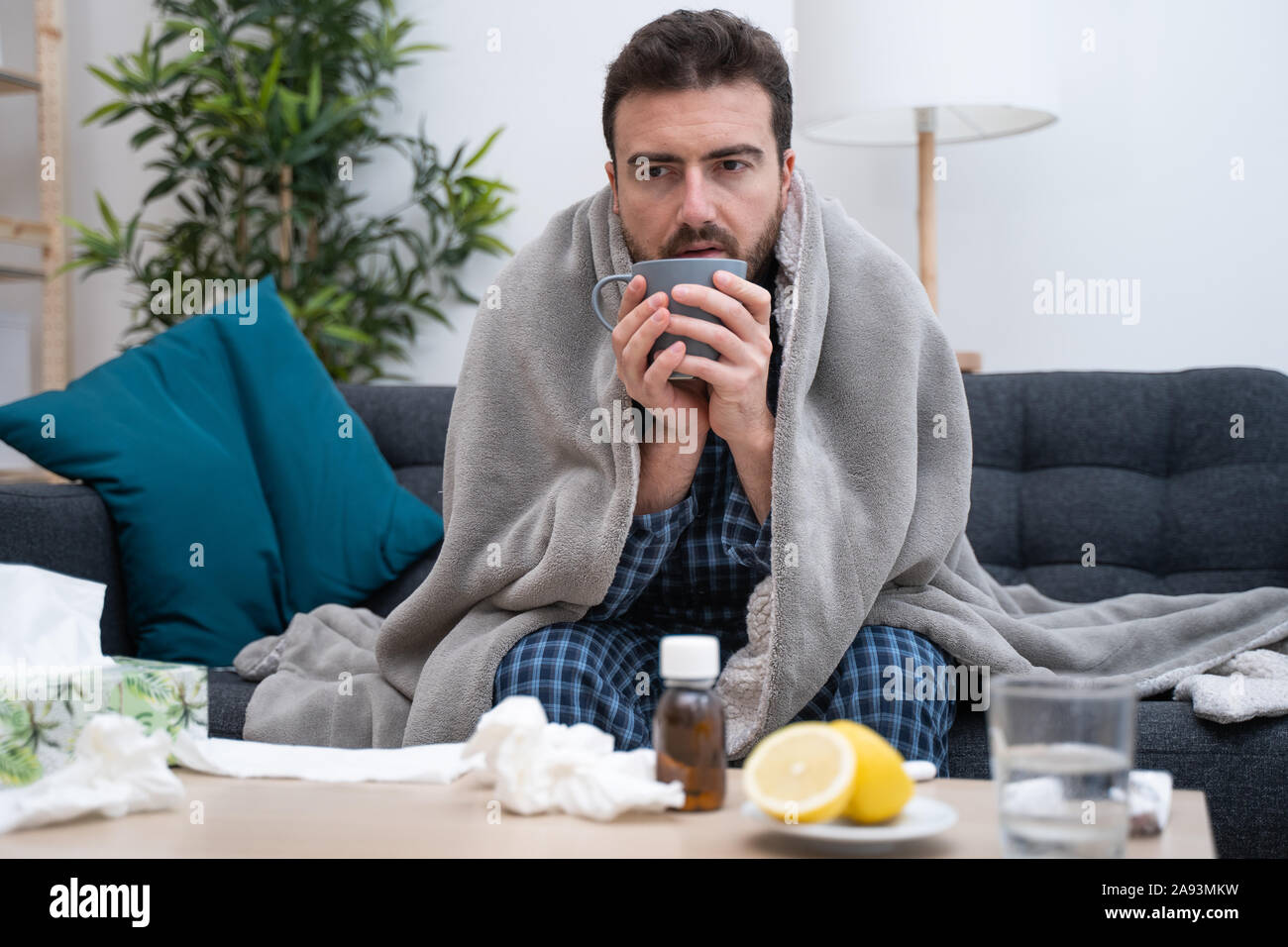 Man portrait suffering cold and flu at home Stock Photo