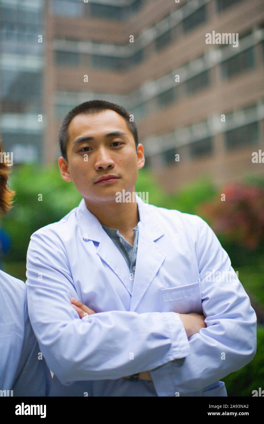 Young adult man wearing a lab coat Stock Photo
