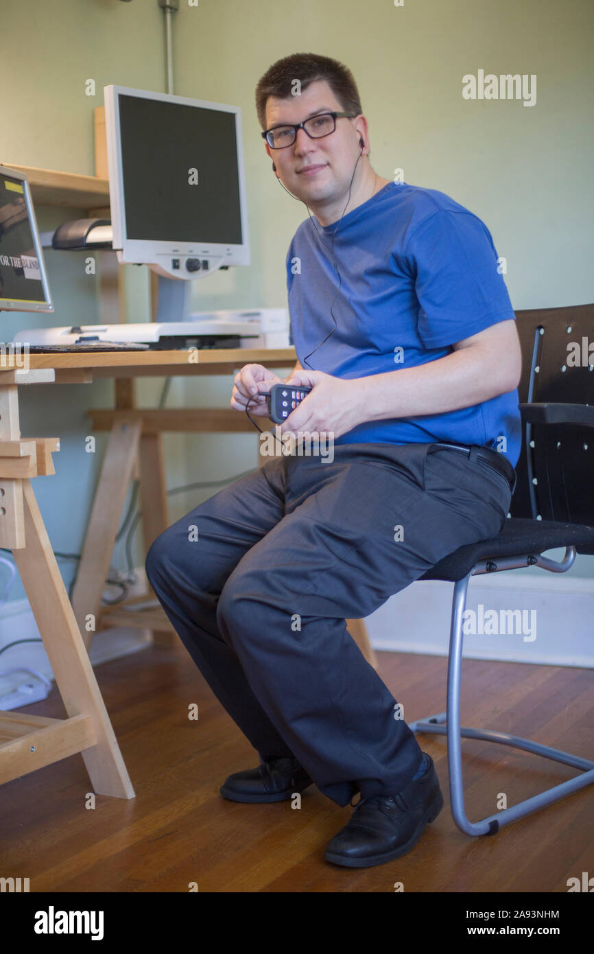 Man with Visual Impairment using his technology to communicate Stock Photo