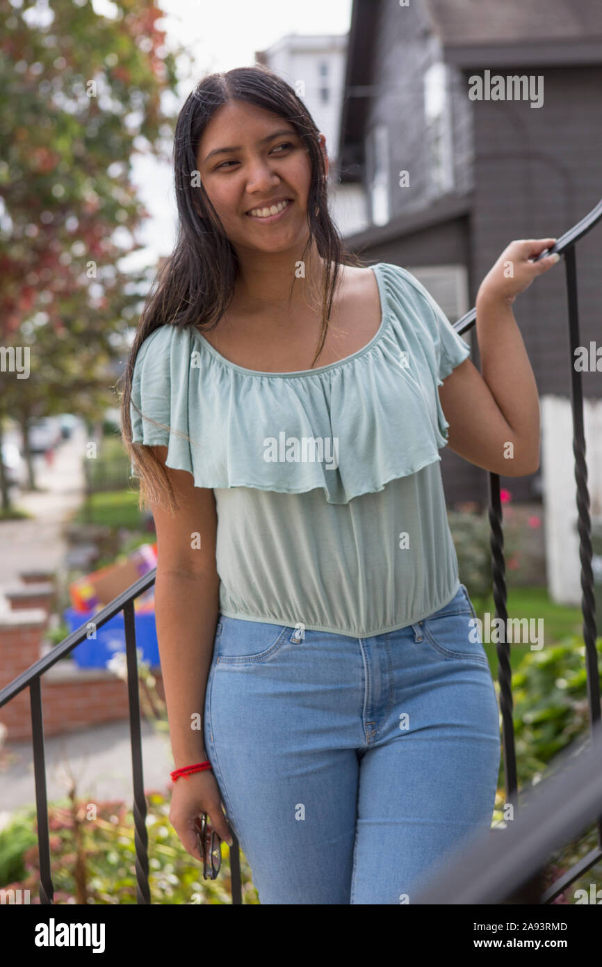 Girl standing outside of house hi-res stock photography and images - Alamy