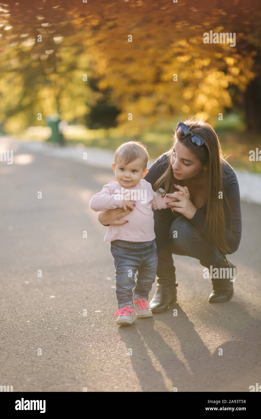 Happy little girl walk with mom in autumn in the park Stock Photo - Alamy
