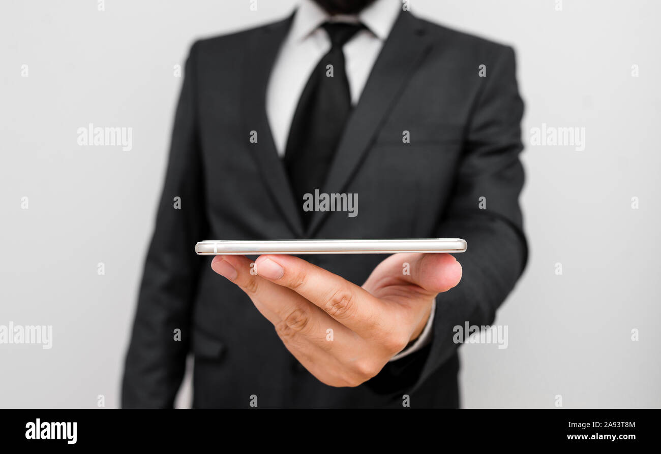 Male human wear formal work suit hold smart hi tech smartphone use one ...