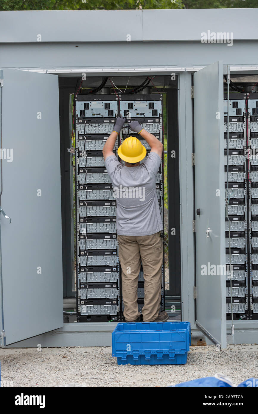 Engineers connecting energy storage batteries for back up power to an electric power plant Stock Photo