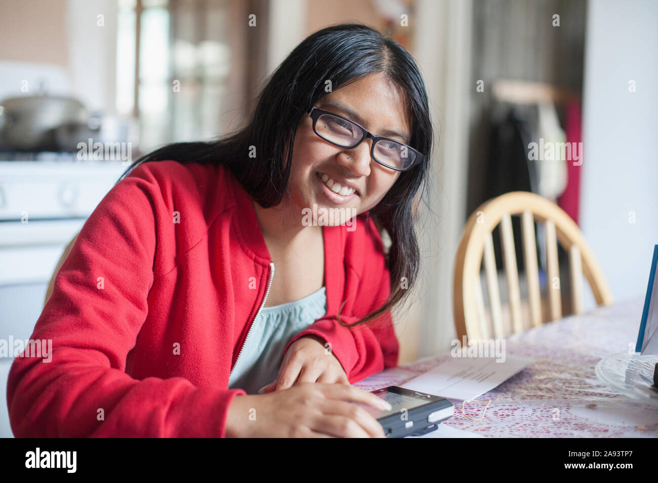 Woman with visual impairment using her electronics as a visual aid 