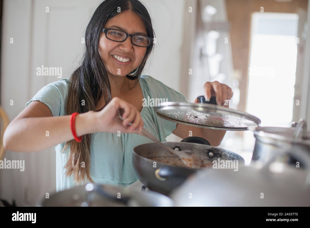 Woman with Visual Impairment cooking food in the kitchen Stock Photo