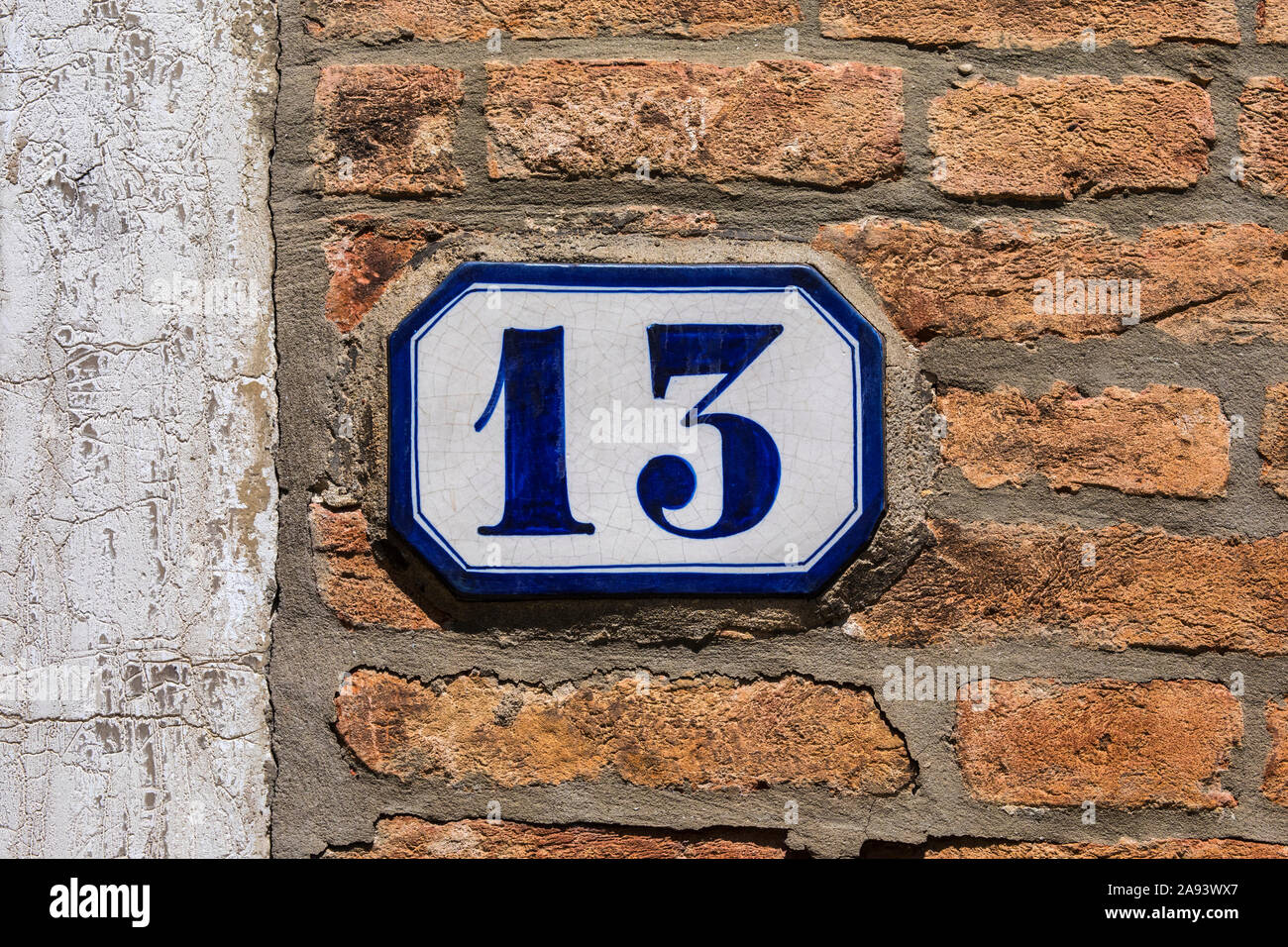 A tile on a wall displaying the number 13 Stock Photo - Alamy