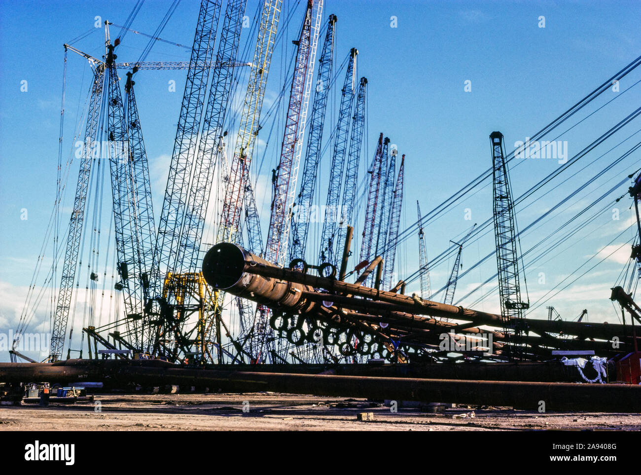 Multiple cranes and winches lifting a section of an oil production platform at the McDermott Construction yard, 1979.  Ardersier, Scotland, UK Stock Photo