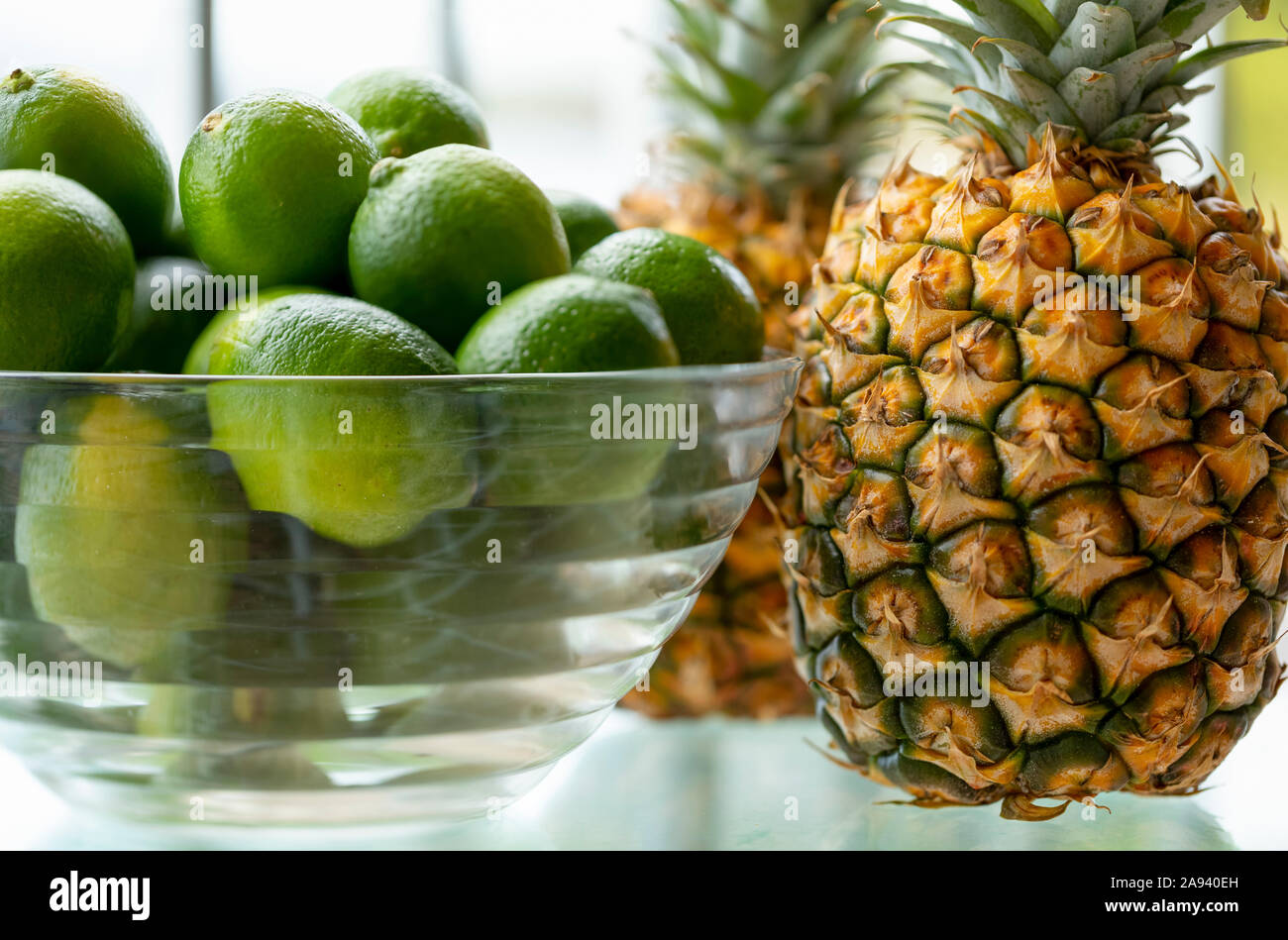 Pineapples and limes sit on a counter; Kihei, Maui, Hawaii, United