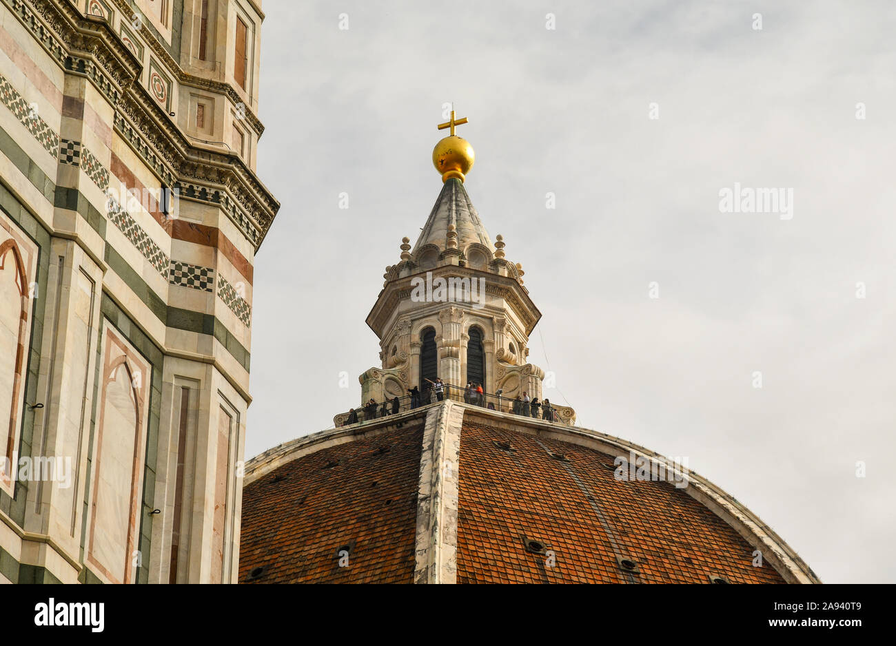 Top of the Dome of the Cathedral of Saint Mary of the Flower by Filippo Brunelleschi (1436) with tourists on the balcony, Florence, Tuscany, Italy Stock Photo