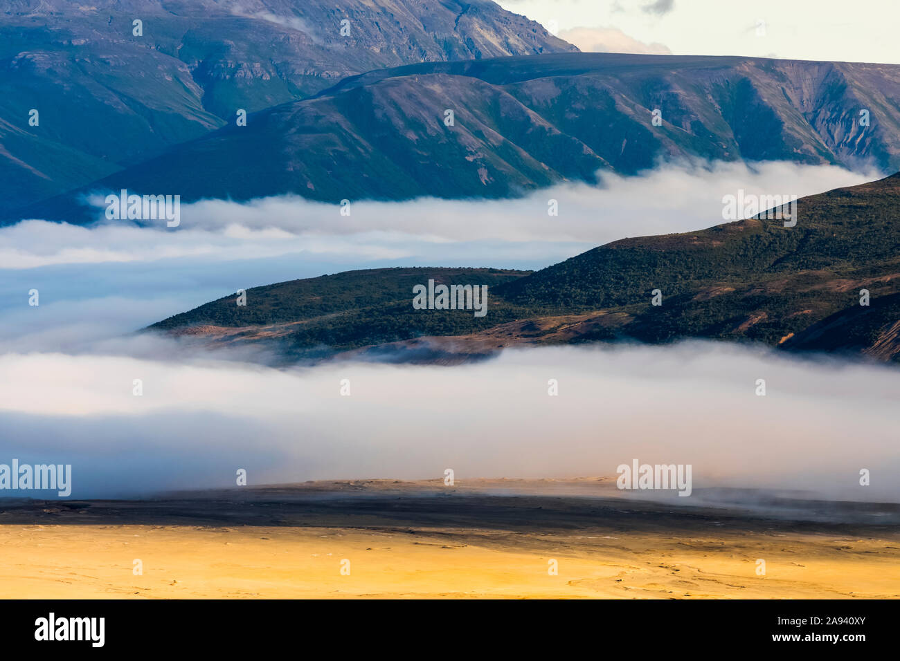 Morning fog covers the edge of the Valley of Ten Thousand Smokes in Katmai National Park and Preserve; Alaska, United States of America Stock Photo
