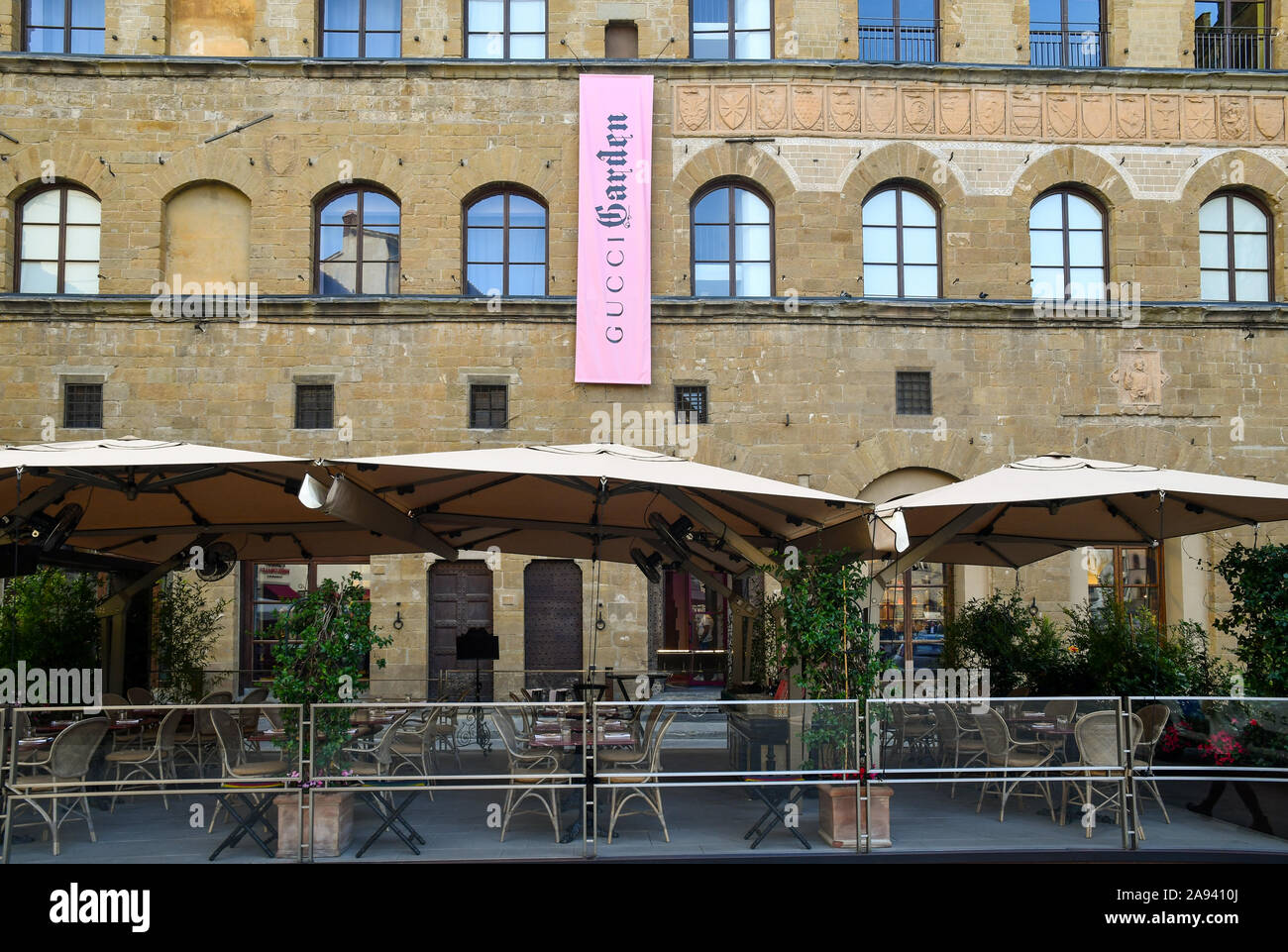 Exterior of Palazzo della Mercanzia in Signoria Square with the banner of Gucci Garden, boutique/restaurant/museum of the maison Gucci, Tuscany, Italy Stock Photo