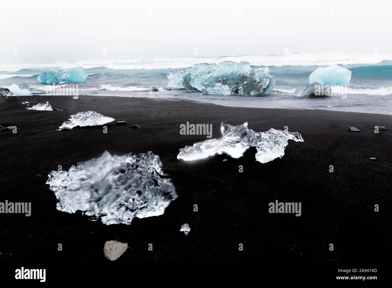 Glistening chunks of ice wash up on a lava black sand beach in the North Atlantic, giving the appearance of diamonds on the beach at Jokulsarlon glaci Stock Photo