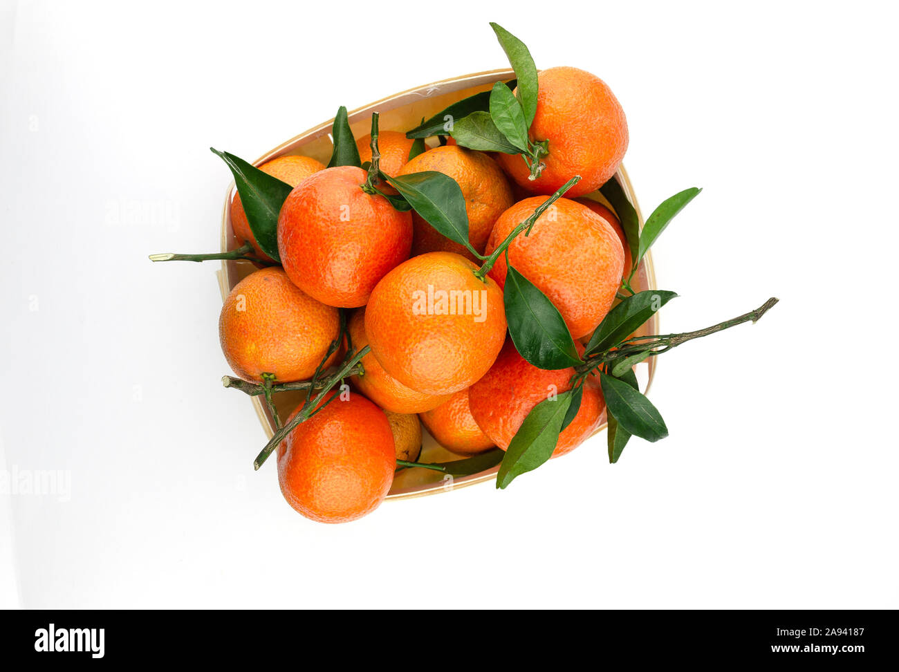 Extra sweet and juicy Spanish clementines with leaves in a basket