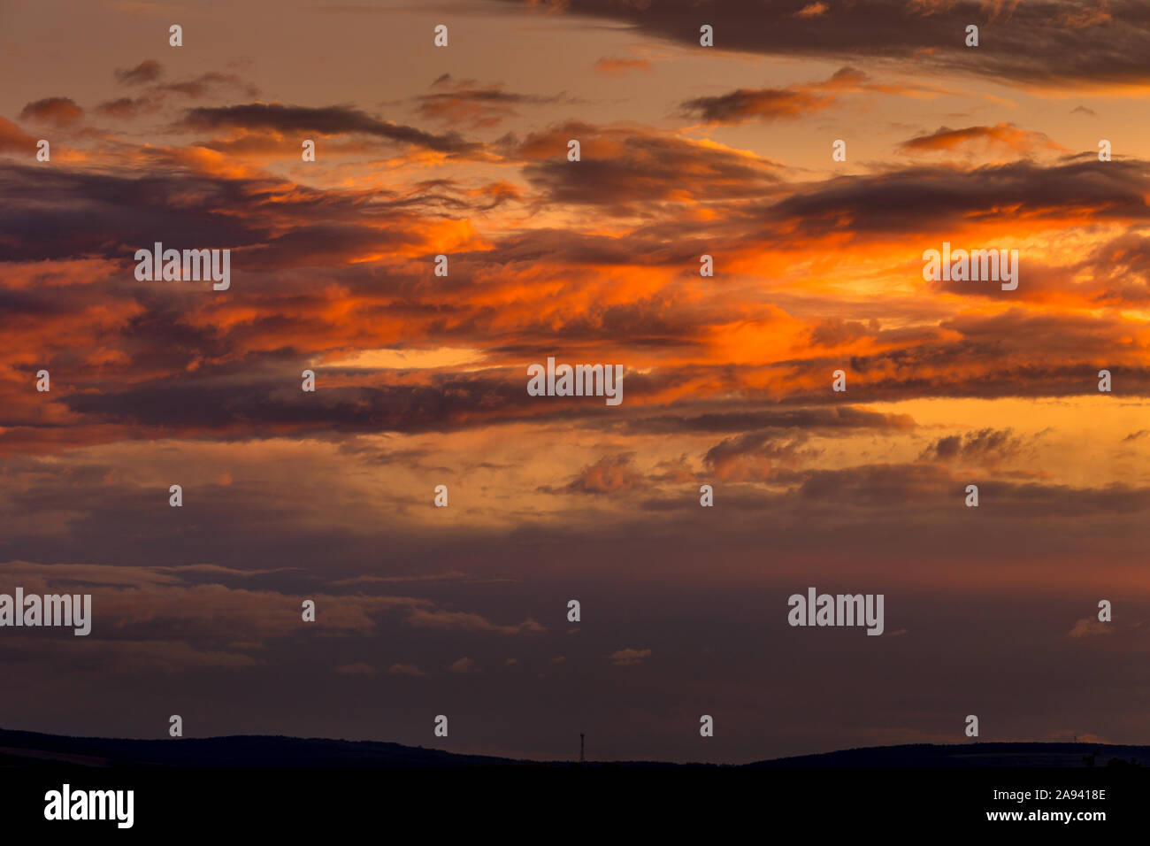 Autumn sky before dawn, the first rays of sunlight color the sky with clouds. Background, texture, space for text. Stock Photo